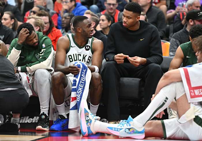 Milwaukee Bucks forward Thanasis Antetokounmpo (34) speaks with his brother, forward Giannis Antetokounmpo at the team bench